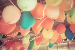 Colorful balloons floating on the ceiling of a party in vintage color